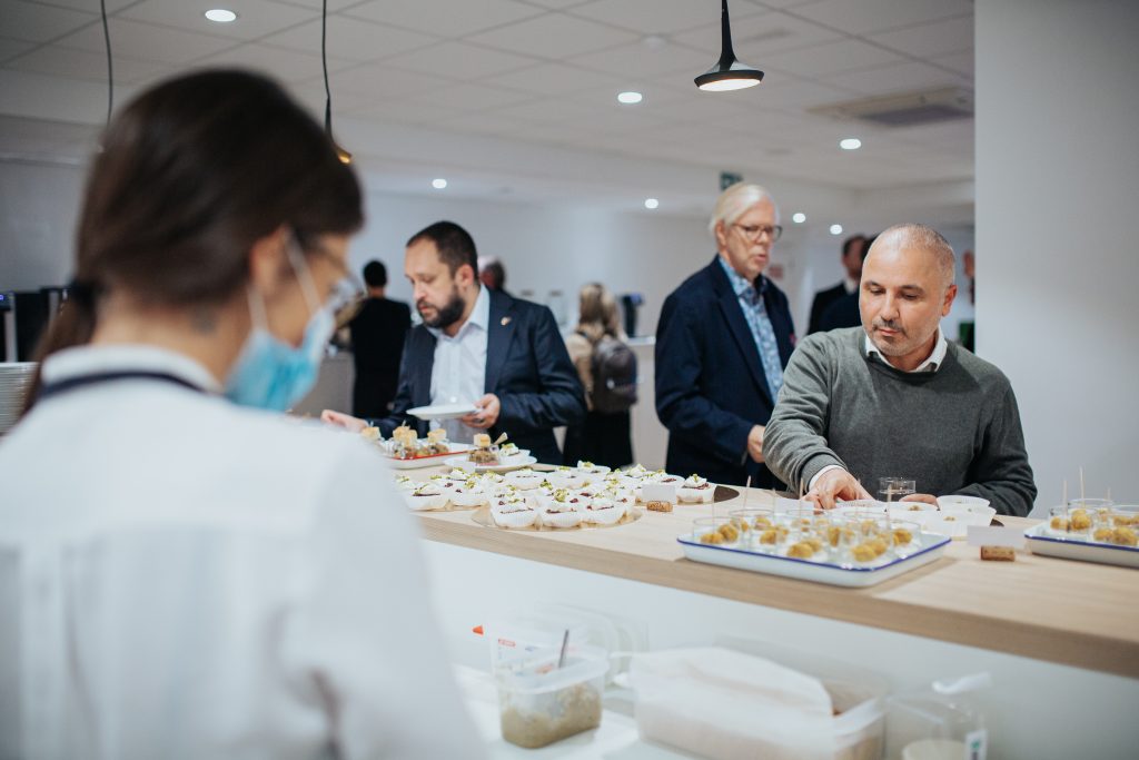 Guests enjoying a business lunch in a corporate event space