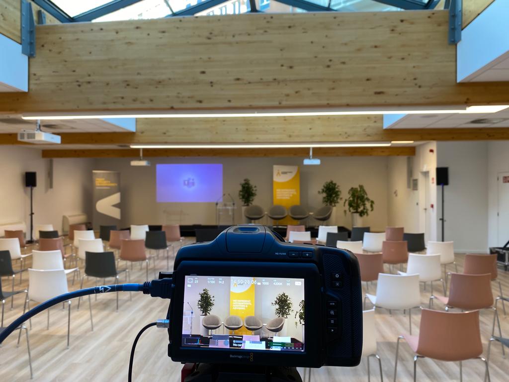 Modern event venue in Brussels with camera setup and projection screen for corporate or private receptions